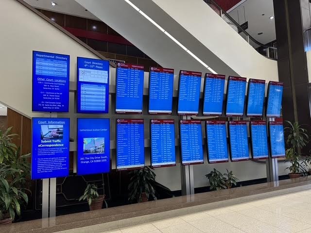 Court directory and calendar monitors inside the Santa Ana Central Justice Center